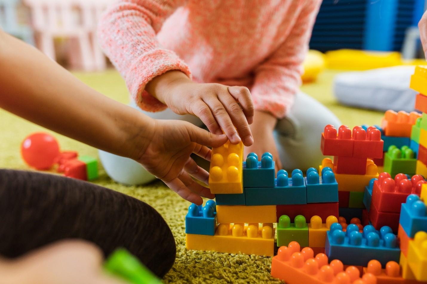 Hand playing with blocks